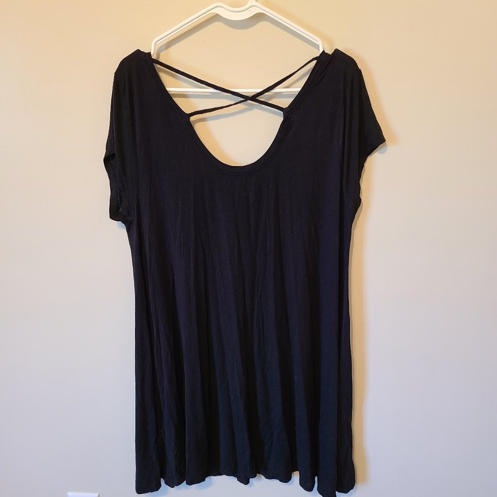 Knee length black dress with cross strap on back.